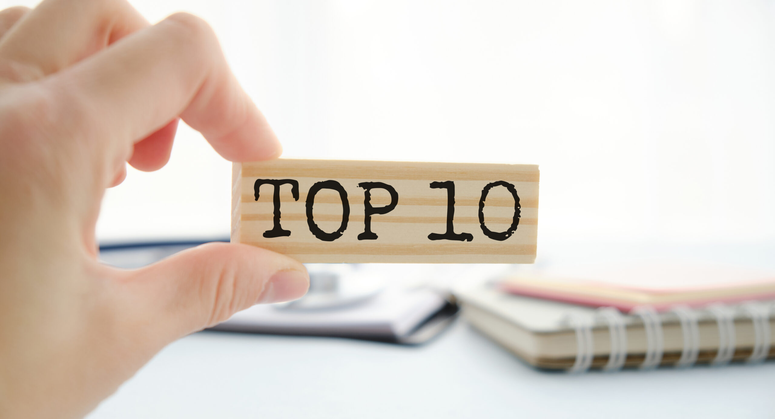 Top 10 sign made of wooden dices on a table i a bright environment with blue colors